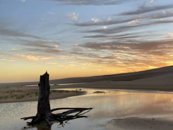 a sunset over a body of water in Stockton Beach