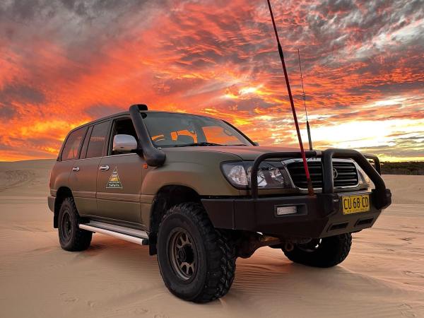a truck parked on a sand dune