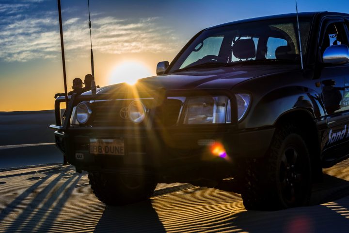a truck cake sitting on top of a car