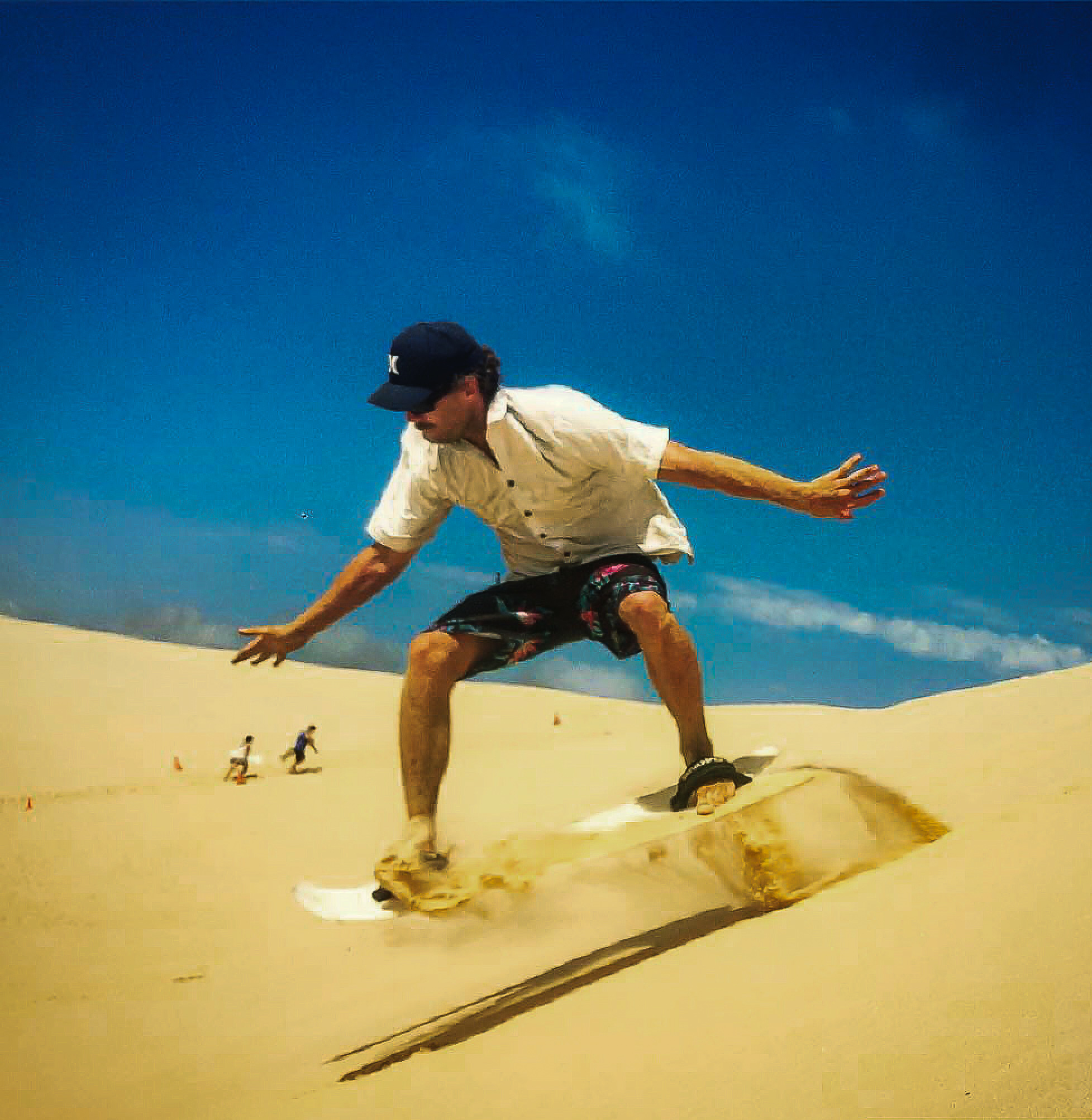 a person sand surfing in Stockton Beach