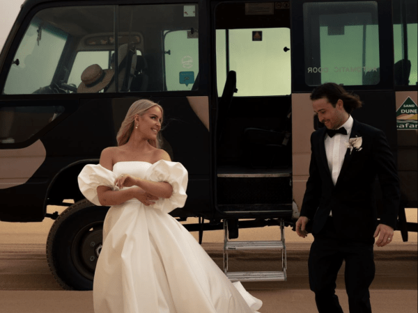 married couple in sand dunes