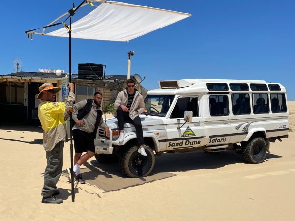 a group of people riding on the back of a truck